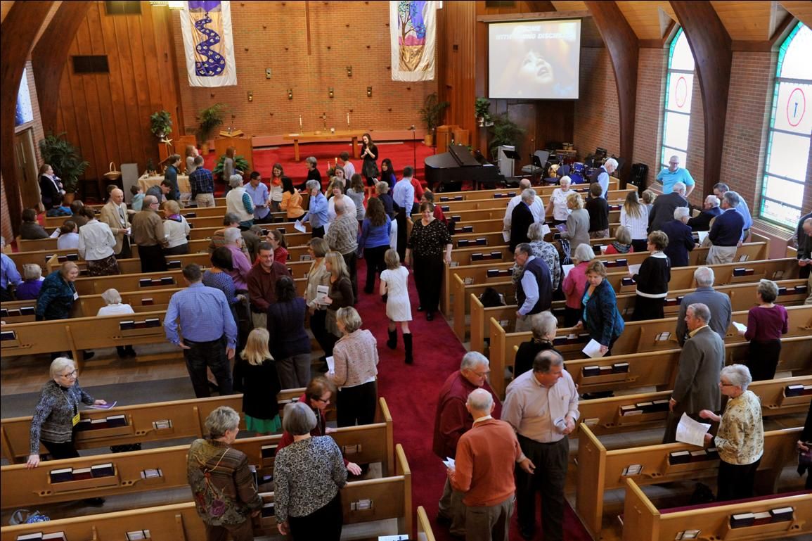 picture of people in a church sanctuary, a congregation gathered